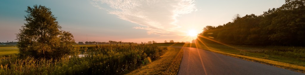 Sunrise whilst travelling along a country road.